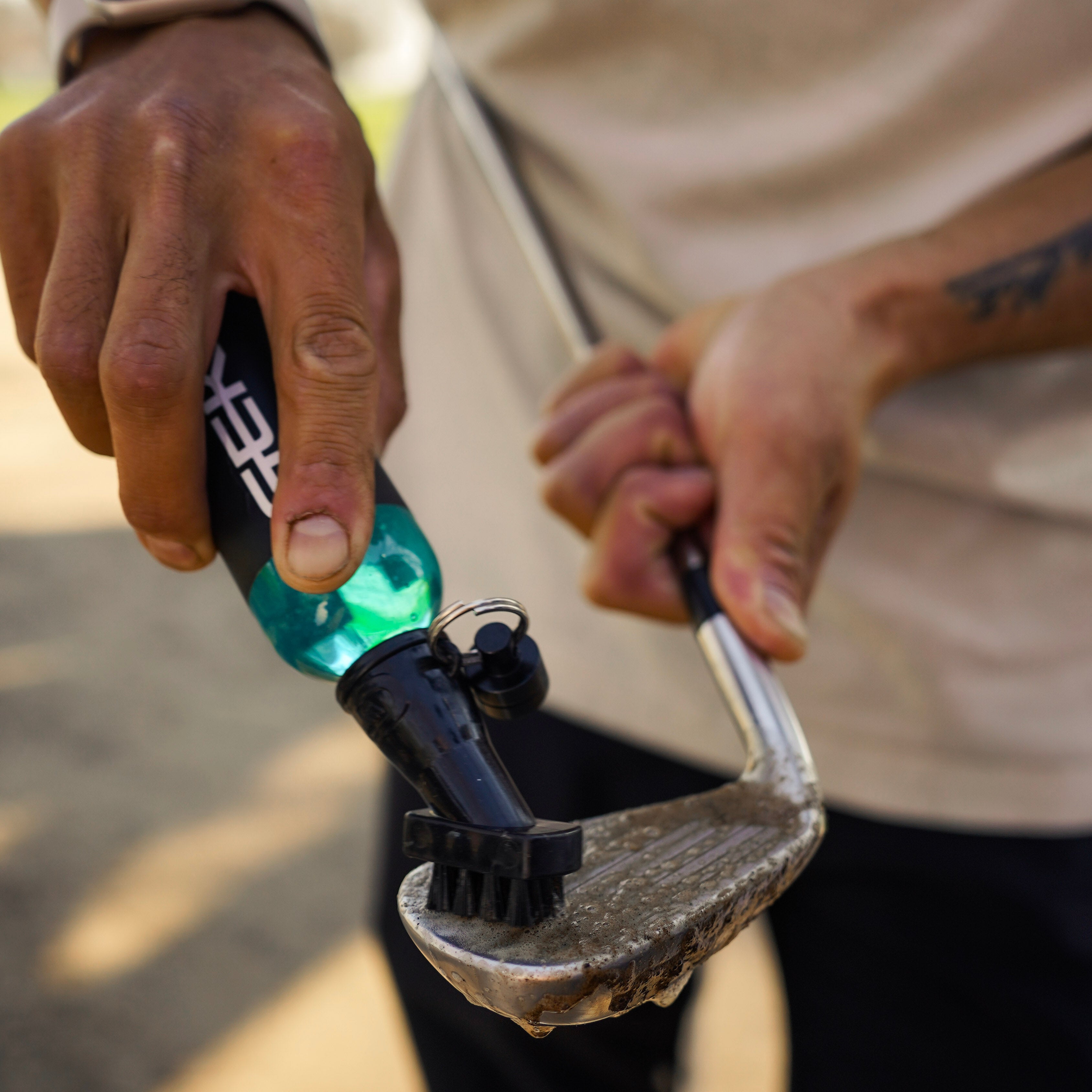 Person holding a geko bottle with a blurred background